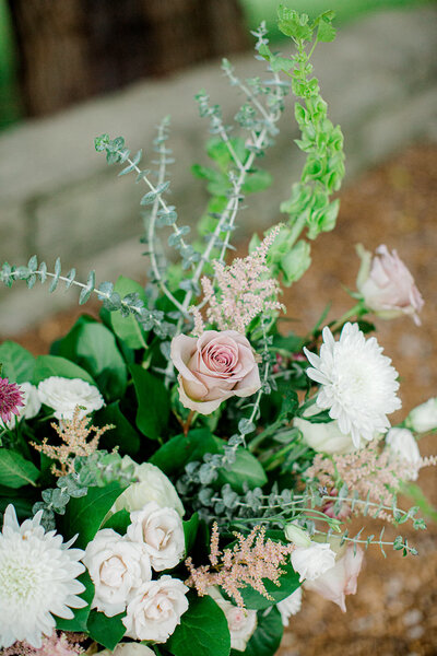 Detail photo of flower arrangements with pink white and greenery