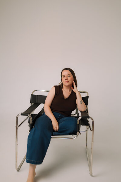 Liv Rollings sitting on rust colored couch