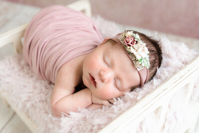newborn baby girl sleeping in tiny wooden baby | studio baby photography