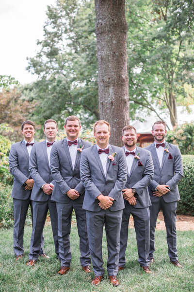 groomsmen portraits at garden wedding venue