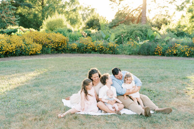 Fine art Catholic wedding photographers Laura and Matthew Schaefer playing with their children on the beach