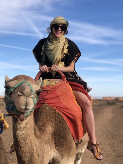 Meg on a camel in Morocco