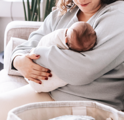 sleeping baby being hold by woman