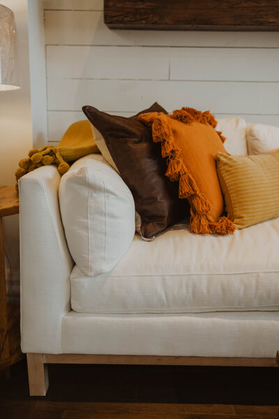 Boho Style Ivory Couch and brown and orange pillows
