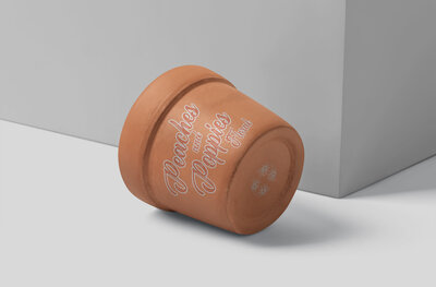 Mockup design for a clay flower pot with company logo on it