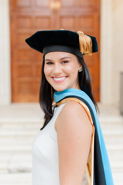 Doctorate graduate smiling into the camera during her Grad photoshoot at Rollins College