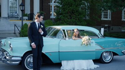 Wedding Couple posing with vintage car in front of the Olmsted Louisville wedding venue.