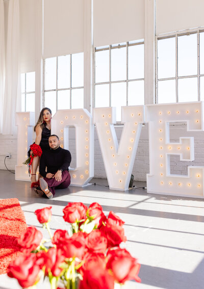 couple's valentine's day portraits love sign red roses san francisco industrial photo studio, photo by Anastasiya Photography - San Francisco Photographer