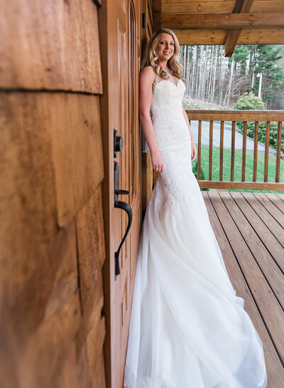 bride standing next to door at a lodge
