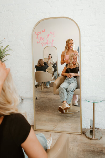 Two hairstylists working inside of Tone Salon Fortville, providing the best salon services int he area. One stylist is blonding, the other is applying gray coverage and balayage.
