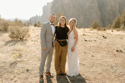 bride and groom posing with photographer at smith rock
