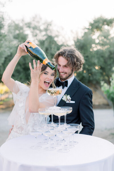 wedding-couple-celebrating-excitement-champagne-pour-happy-moment