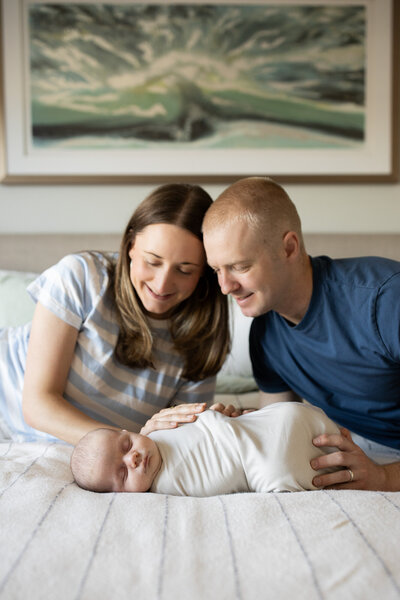 family doting over newborn in nursery.