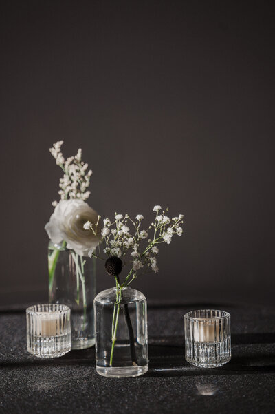 candles and white flowers in glass jars