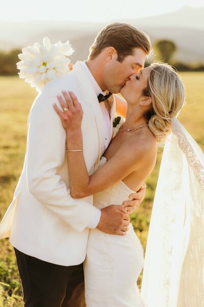 photo of man and woman kissing while standing outside taken by Jackson Hole elopement photographer