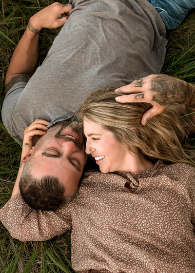 couple laying in the grass together