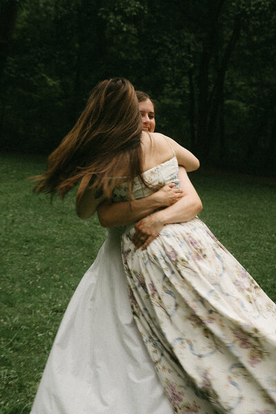bride in white wedding dress dancing and partying at reception with friends
