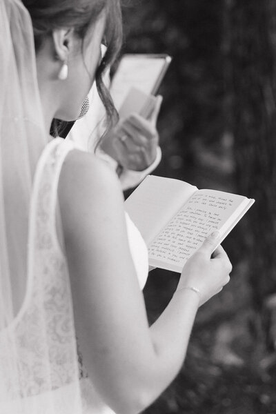 black and white photo of bride reading her vows