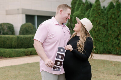 Couple smiling with ultrasound photos