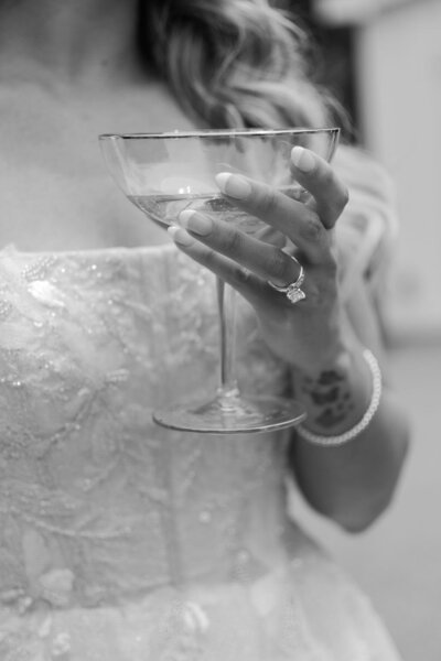 close up of bride holding glass of champagne