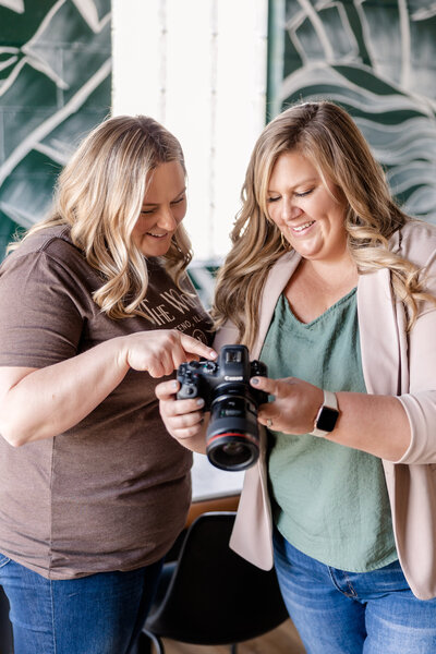 A candid shot of Meg Williamson smiling warmly as she mentors a business owner. The image captures her friendly and approachable nature, reflecting her passion and dedication to her craft.