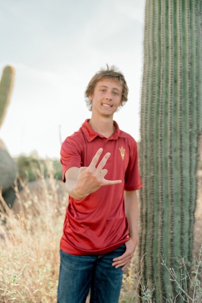 Senior boy posing for graduation portrait in the scottsdale arizona desert