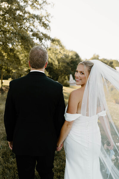 Bride and groom sharing a joyful moment together on their wedding day in Columbus, Ohio, captured in a beautiful outdoor setting.
