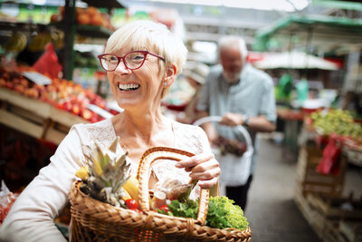 mature-woman-buying-vegetables-at-farmers-market-2021-04-02-21-58-55-utc
