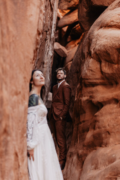 Couple stands in slot canyon for elopement in Utah
