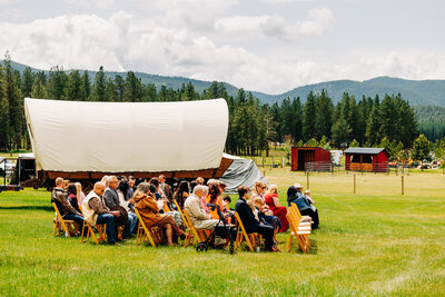 Guests seated at wedding ceremony at P-7 Base Camp in Potomac, MT