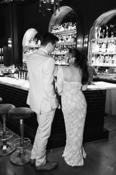 Romantic bride and groom photo by bar