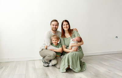 Jessica and her husband holding their toddler
