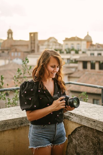Silvia's portrait in Rome at sunset while she holds her camera