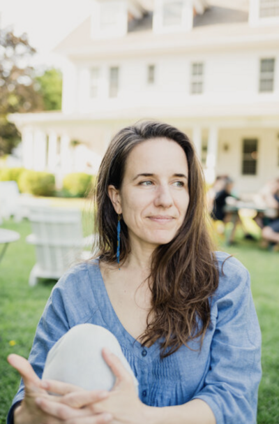 In-home newborn photography specialist Rebecca Bloomfield sitting outdoors in Northwest Connecticut, captured in natural light