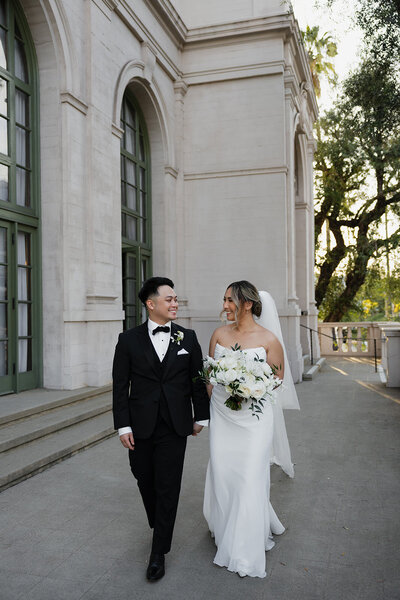 COVER-radiant-love-events-bride-groom-knees-up-standing-next-to-eachother-smiling-at-camera-outside-romantic-elegant-timeless