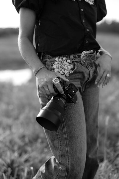 photo of camera against flowers in a jean pocket