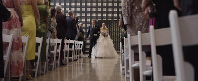 Bride walking down aisle with father
