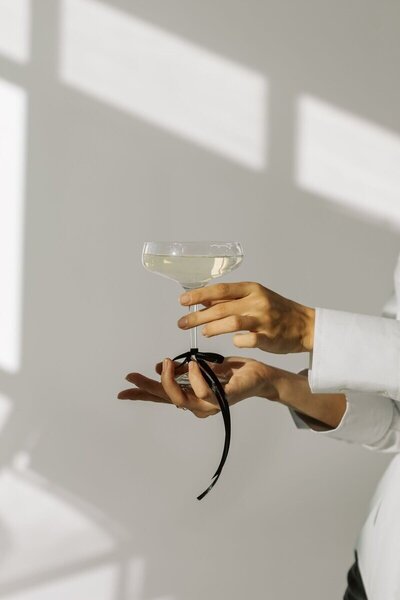 Kristina from Kmotion, a creative professional and Showit website builder, holding a wine glass.

