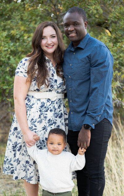 Family smiling on during their golden hour photo session in Draper, Utah