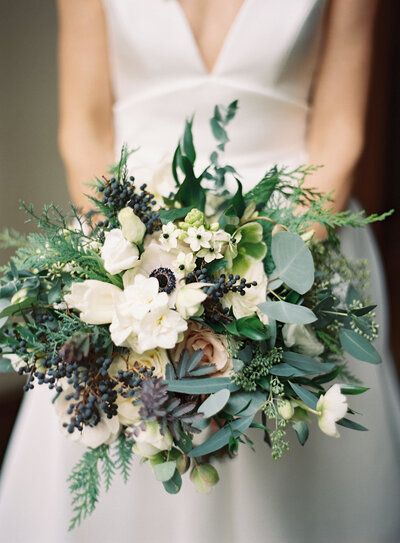 Close up of a bride holding a floral bouquet 