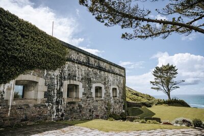 A view of the fort from ground level with the green grass and blue sky in the background