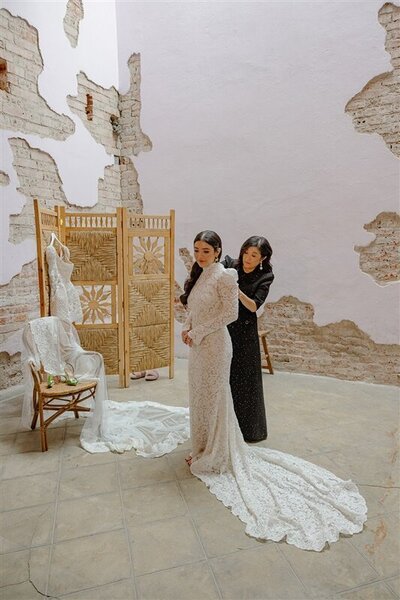 Bride getting ready before her Mexico City wedding, wearing a lace gown by Watters