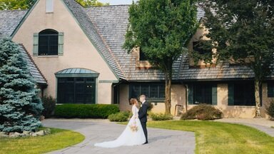 Midwest wedding couple at Basil Place posing in front of wedding venue.