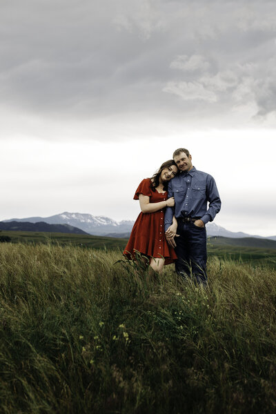 Moody spring engagement photos at the base of the Tobacco Root Mountains in Ennis, Montana