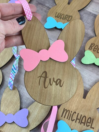 Wooden Easter bunny tag with pink bow and name engraved in the center