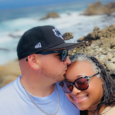 Letitia Hopkins in Monterey receiving a forehead kiss from her husband, embodying love, emotional connection, self-worth, and Main Character Energy as a life, love, and relationship coach guiding women to create aligned, fulfilling relationships.