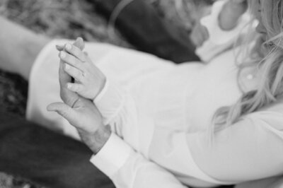 Engaged couple holds hands. Black and White photo by Anna Brace, one of Lincoln Wedding photographers.