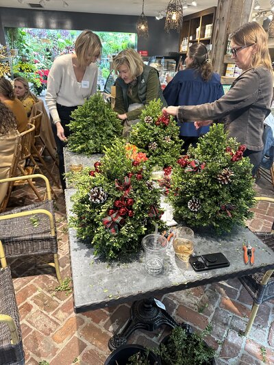 women decorating trees on a table at event