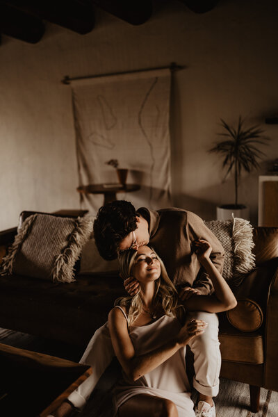 couple holding eachother cuddling in home