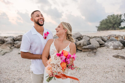 Couple elopes with bright tropical colors on the beach in Treasure Island, FL
